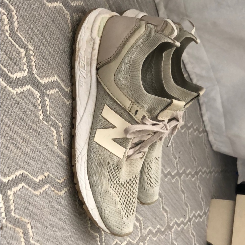 Cream colored new balance running shoes